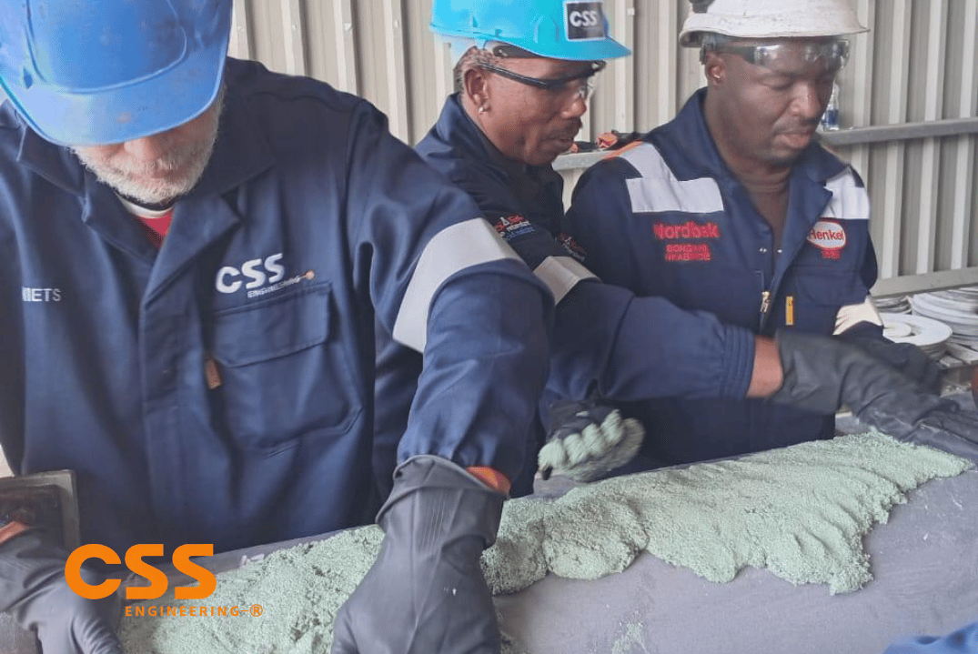 CSS Engineering and Nordbak technicians applying wear-resistant lagging to a roller on site