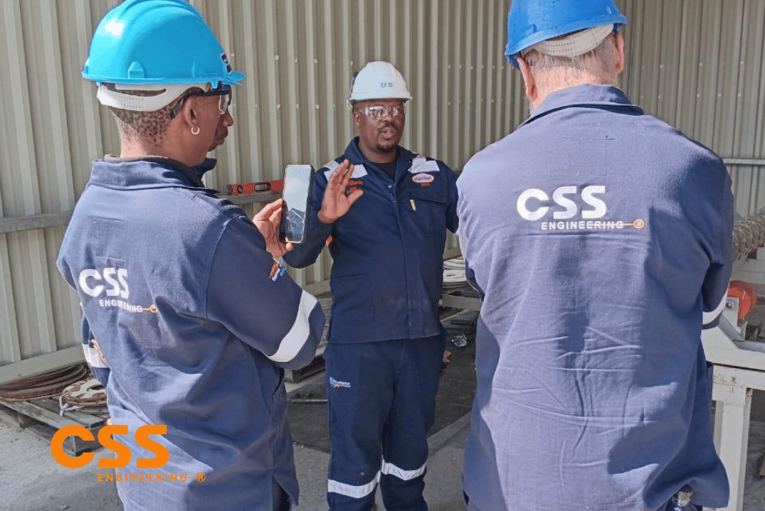 CSS Engineering and Nordbak team lifting a wear-lined roller into position on site